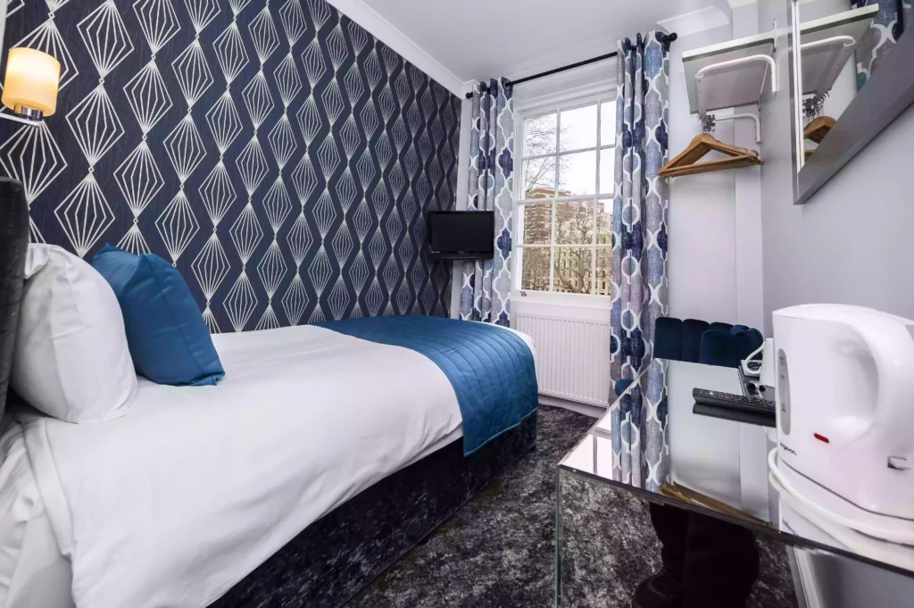 Small and modern bedroom in the Single En-Suite Room at the Mentone Hotel