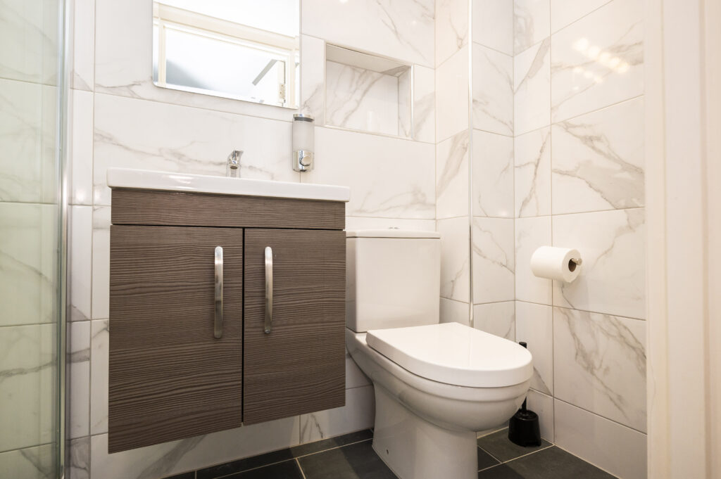 Small, modern bathroom in the Mentone Hotel rooms