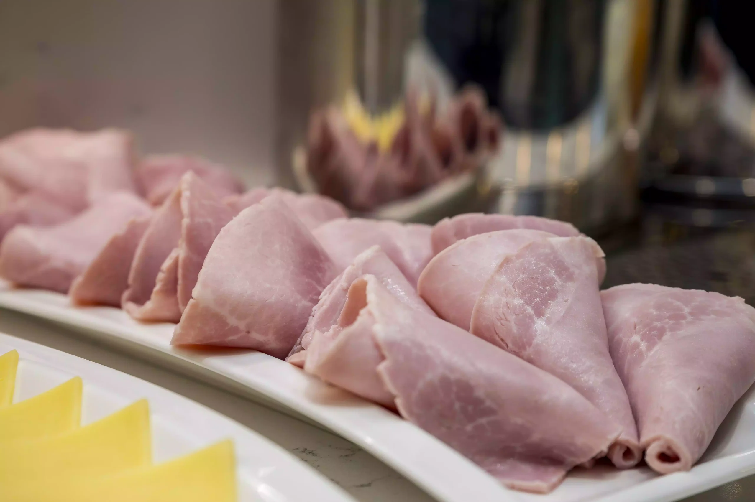 Slices of ham neatly arranged in rows, ideal for breakfast