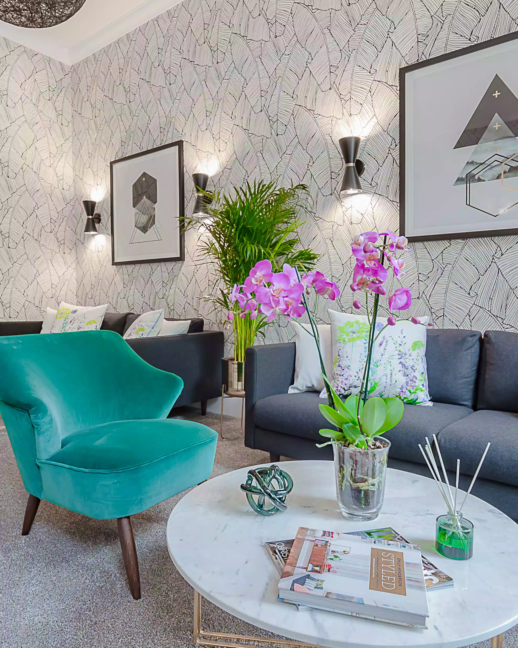 Modern living room at the chic Mentone Hotel with a teal and blue sofa and a round marble coffee table