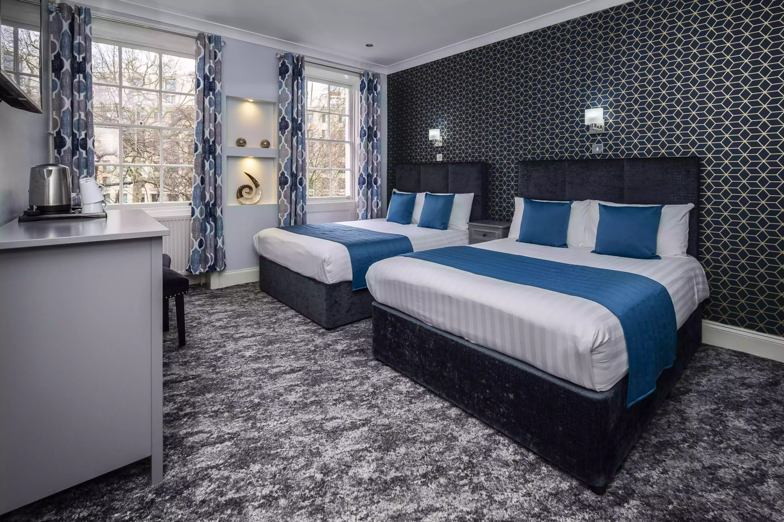 Cozy room at Mentone Hotel with two double beds, equipped with a kettle and mugs