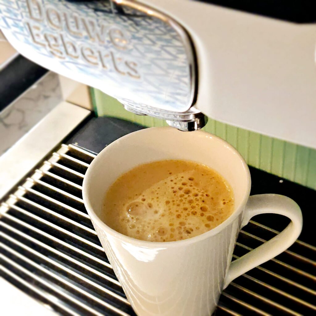 A cup filled with coffee from a coffee machine